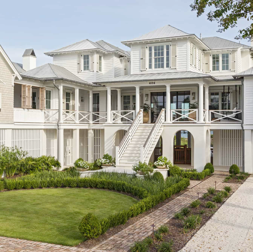 Low-country style beach home with green lawn and ocean views