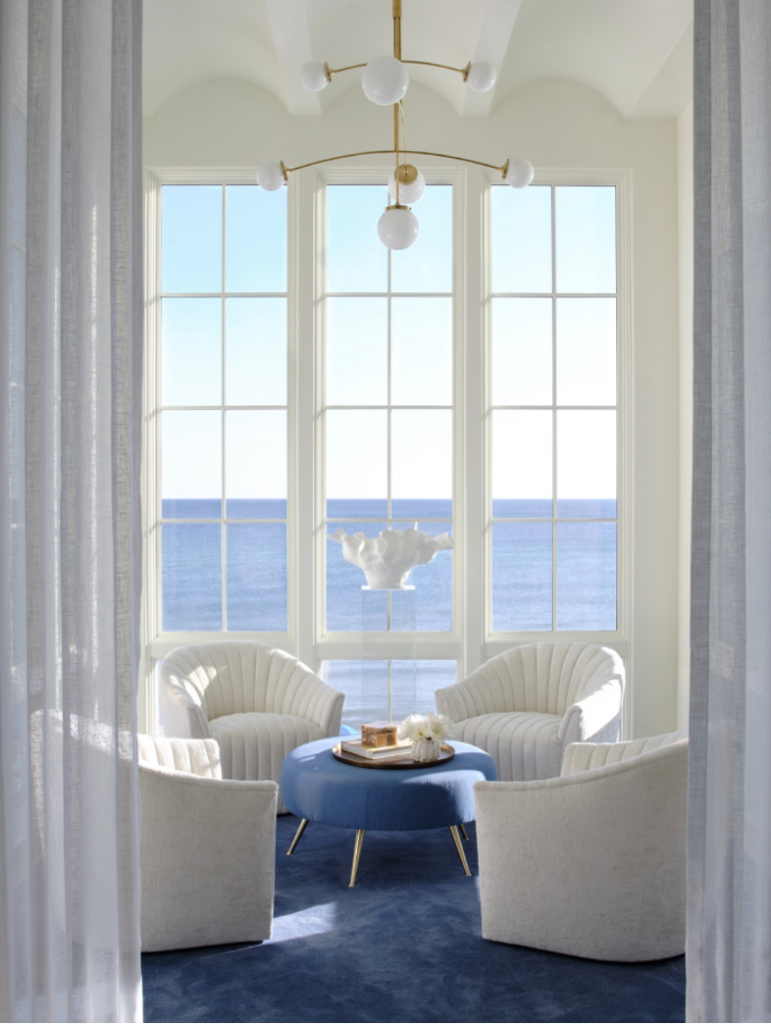 Beach home's "jewel box" room featuring panoramic blue ocean views