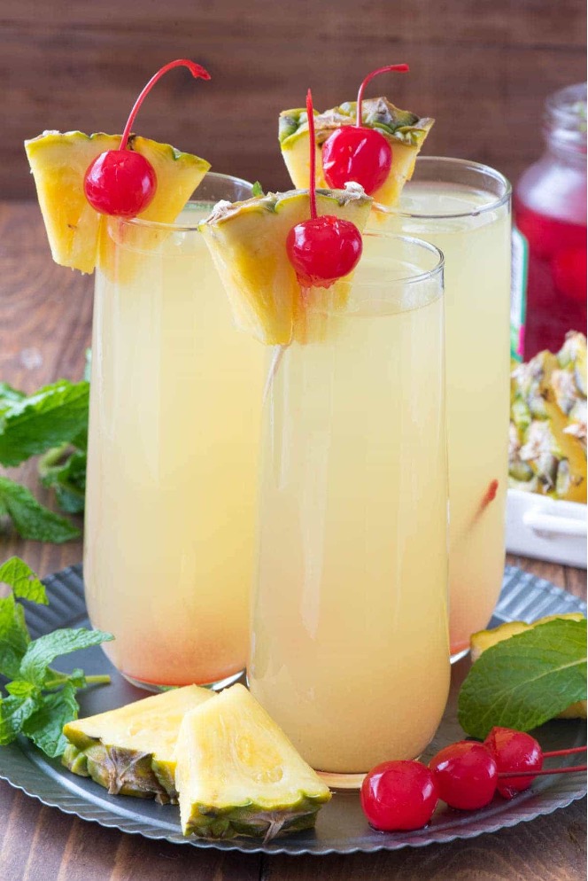 Hawaiian mimosas with coconut rum, pineapple juice, and champagne or Prosecco