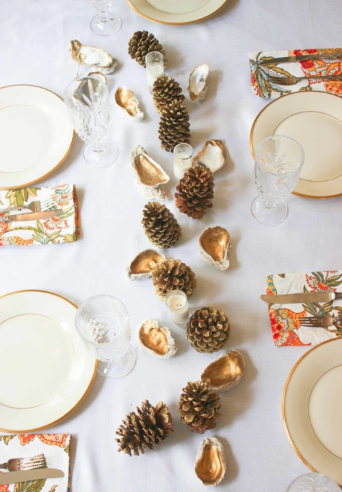 Tablescape with pine cones and painted oyster shells