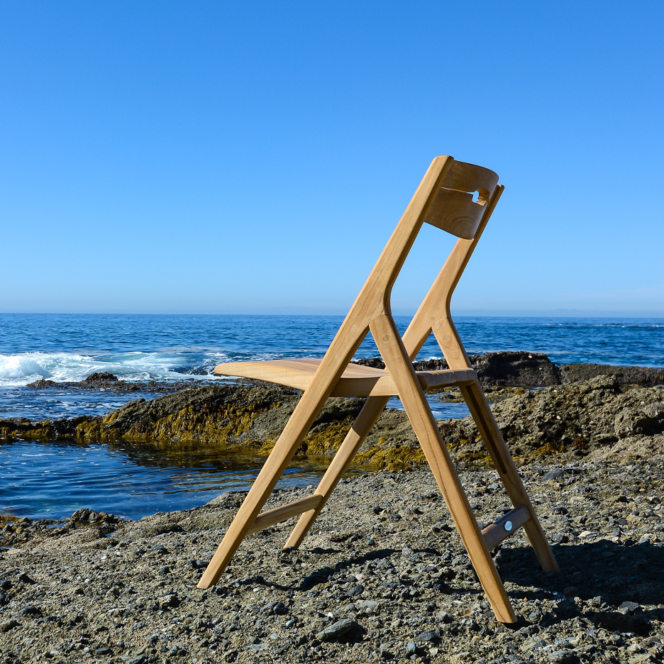 Teak Sur Chair from Westminster Teak sitting on a rocky coastline.