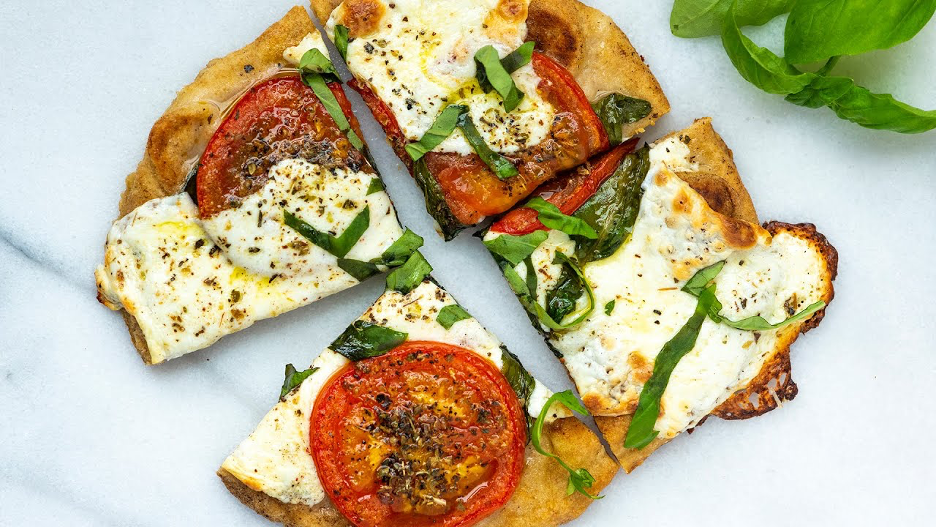 Charred Tomato and Herb Flatbread Pizza cut into four squares