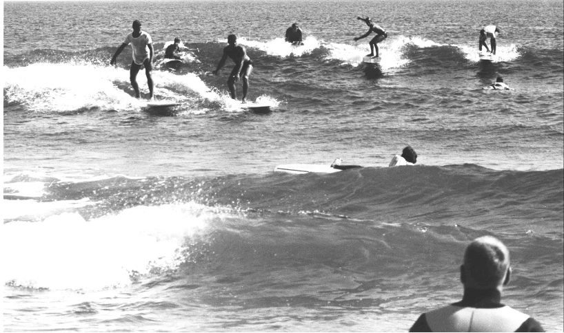 Early days of surfing in black and white with surfers on the waves in Montauk, Long Island, NY