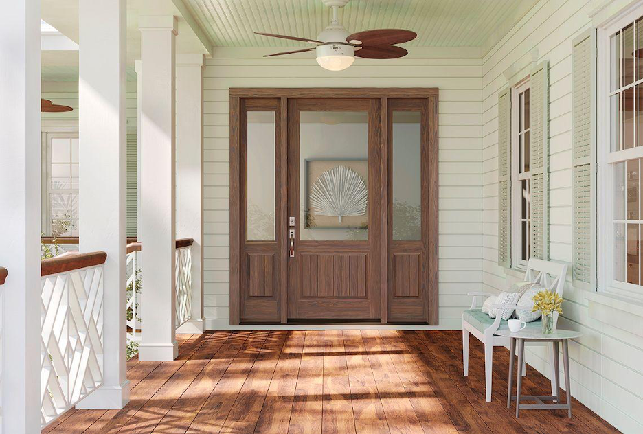 Front door system with refreshed hardware for a coastal home with a covered porch, ceiling fan, plank flooring