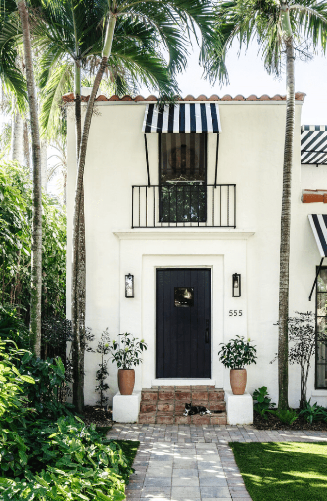 Upgraded front entrance hardware and door numbers for a Florida villa in a crisp black and white palette