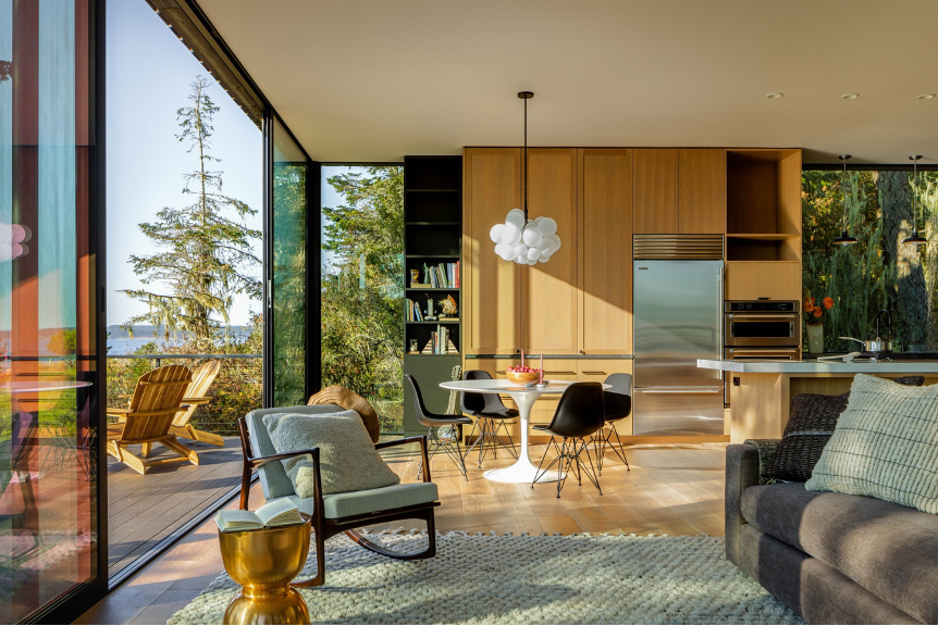 Living and kitchen area all connect to the outdoor deck via a large glass wall of folding doors for seamless indoor-outdoor access