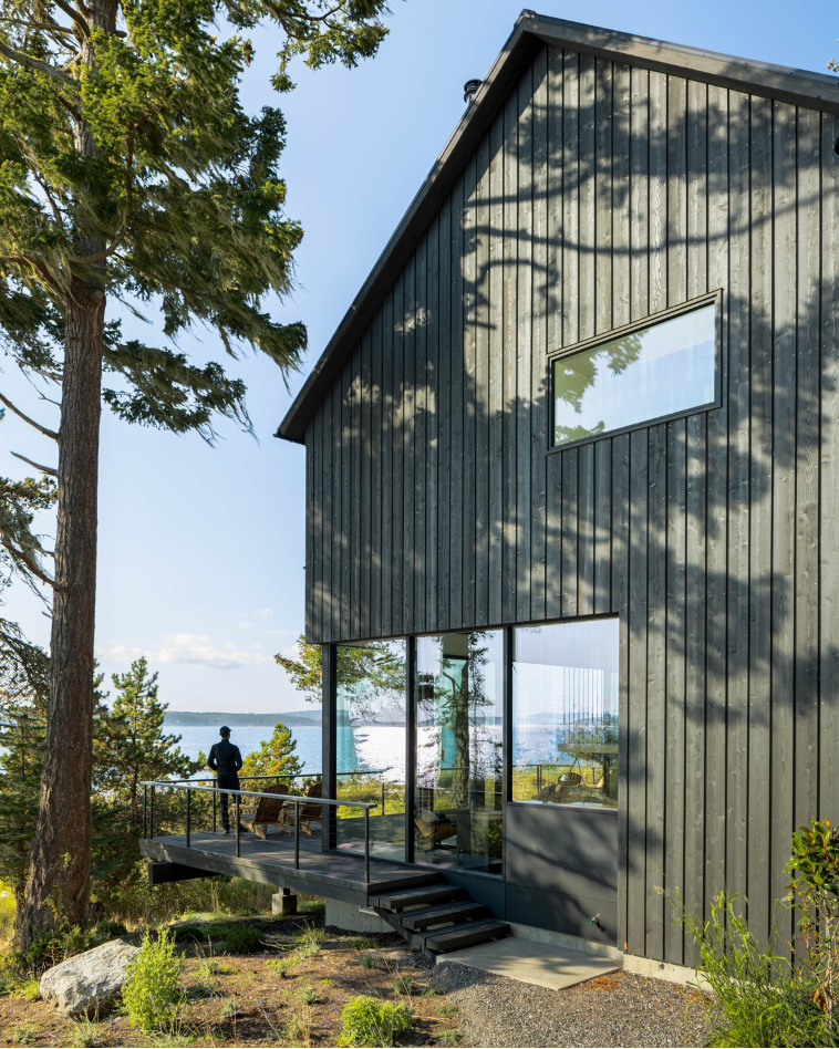 Side view of home exterior with ocean backdrop