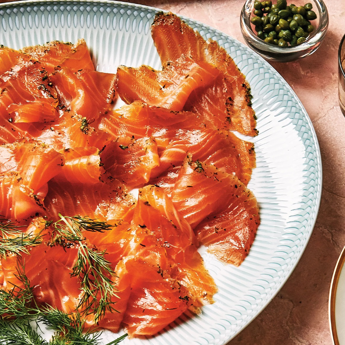 Citrus-Dill Gravlax on a platter with dill garnish and a side of capers