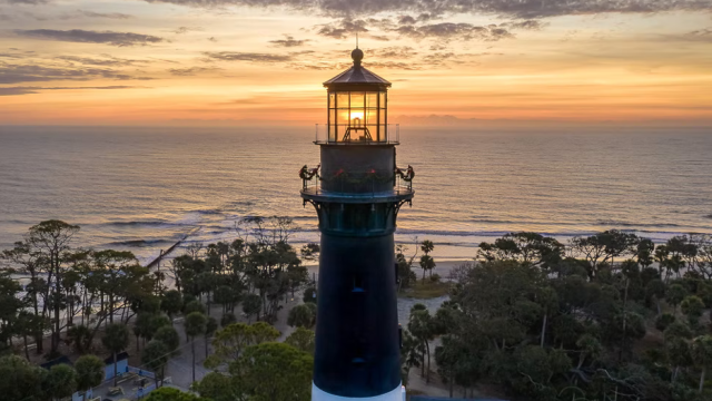 The lighthouse on Hunting Island State Park – Beaufort, South Carolina, at sunset with ocean backdrop