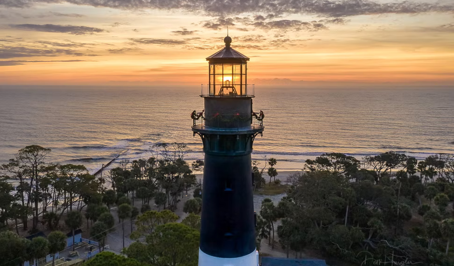 The lighthouse on Hunting Island State Park – Beaufort, South Carolina, at sunset with ocean backdrop