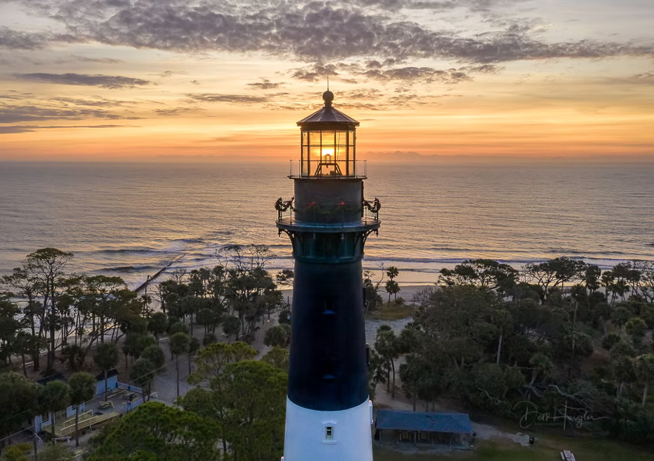 The lighthouse on Hunting Island State Park – Beaufort, South Carolina, at sunset with ocean backdrop