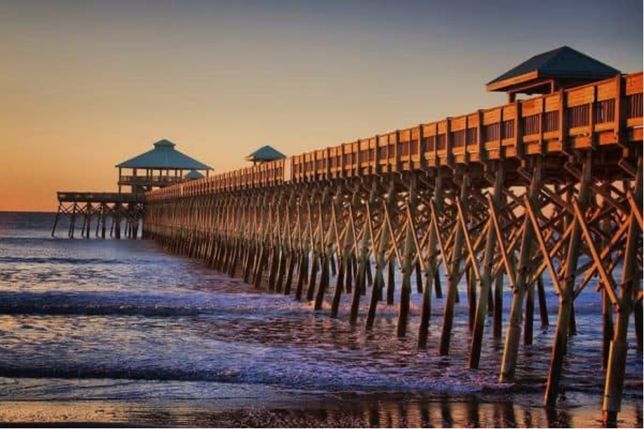 A long pier jutting out over the ocean waters of Folly Beach – Charleston, South Carolina