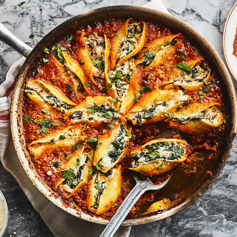Vegetarian Skillet Stuffed Shells that are stuffed with ricotta cheese and spinach, and baking in a tomato-based sauce 