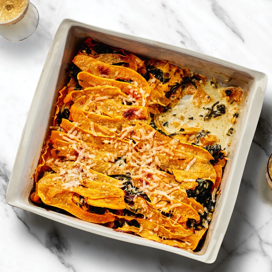Butternut Squash and Creamed-Spinach Gratin in a baking dish atop a marble surface