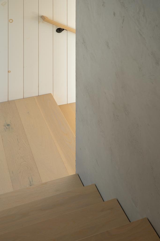 Staircase, partially enclosed, but yet illuminated from the natural light on the first floor