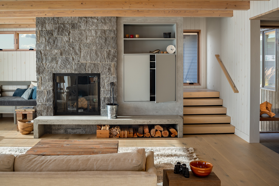 living room area with compressed ceiling over the stone fireplace to create an intimate ambiance on chilly nights