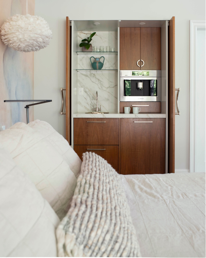 Cleverly Concealed coffee bar with pocket doors in a primary bedroom or guest suite
