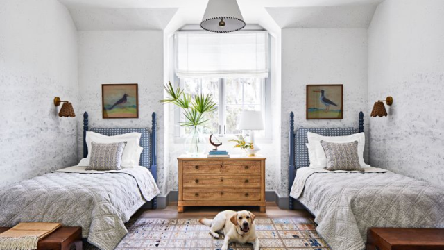 space-saving Beach bedroom with twin beds, wall sconces, storage trucks, and roomy dresser for more storage