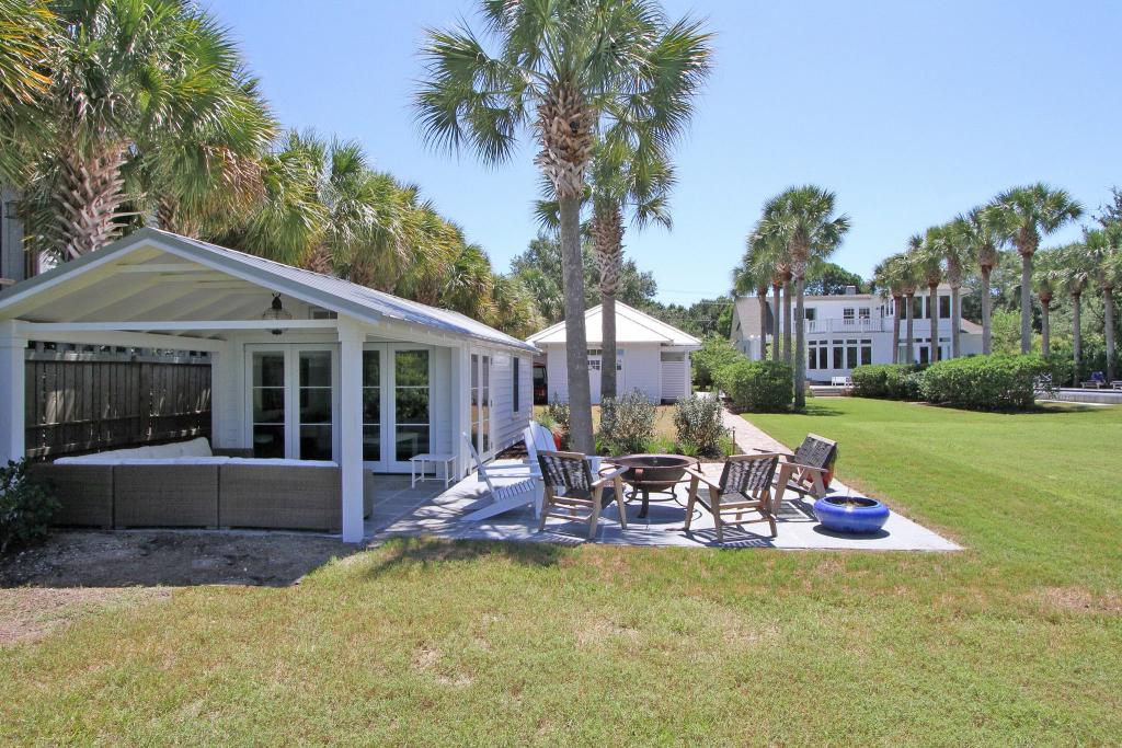 Outdoor Living, Jasper Blvd., Sullivan's Island, Diament Builders. The garage functions as a pool bathroom and includes surfboard storage, golf-cart parking and attic storage, while the surrounding landscape connects the garage with the pool and outdoor living spaces.