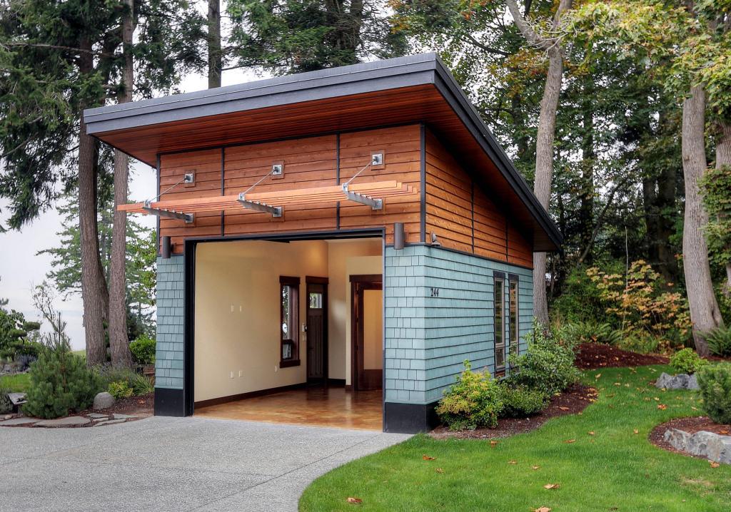 Woodlawn Studio, Camano Island, WA, Dan Nelson, Designs Northwest Architects. The modern detached structure combines warm wood siding, a generous garage opening and a polished architectural presence that makes the building feel more like a studio than a utilitarian outbuilding.