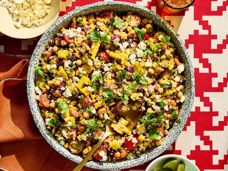 Dense Bean Salad with Charred Jalapeño-Lime Dressing in a serving bowl with spoon.